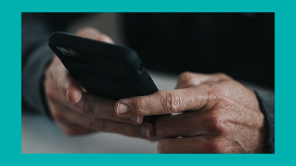 A man's hands holding a smartphone