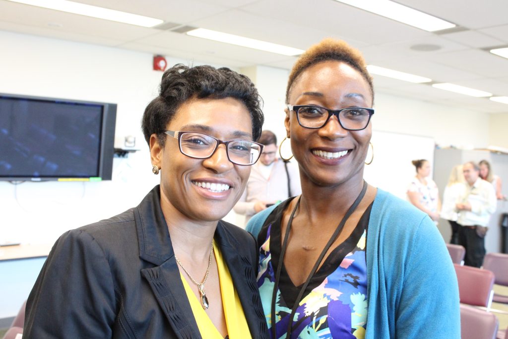 Two women of colour smile toward the camera, Dania Versailles, Dir. Clinical Services, and Tracy Charles, case manager, dual diagnosis program