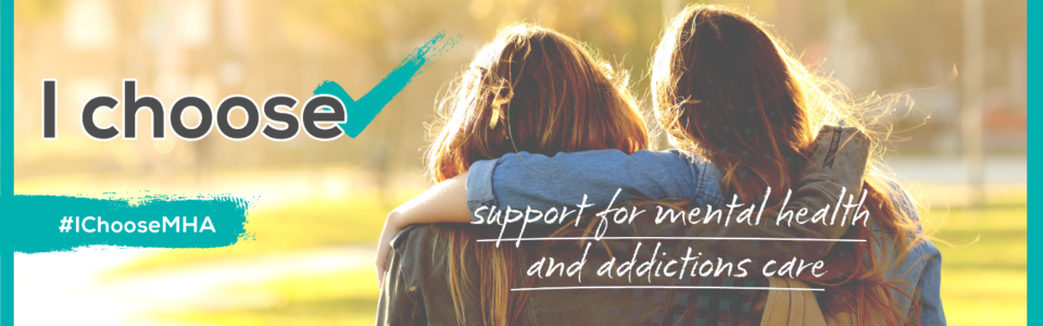Two friends stand arm in arm, facing the sunlight -- the caption reads "I choose support for mental health and addictions."